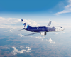A Boeing 737 in Avia Solutions Group livery, featuring a dark blue fuselage with a white-blue zebra design. The aircraft flies against a bright sky with scattered clouds and landscape below.